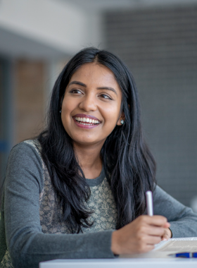 Smiling person writing a note