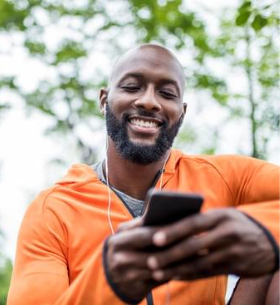 Person with earphones checking cell phone