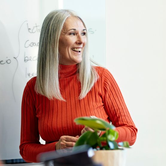 woman standing in front of whiteboard