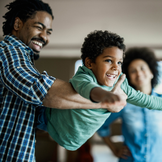 Father smiling and playing with son
