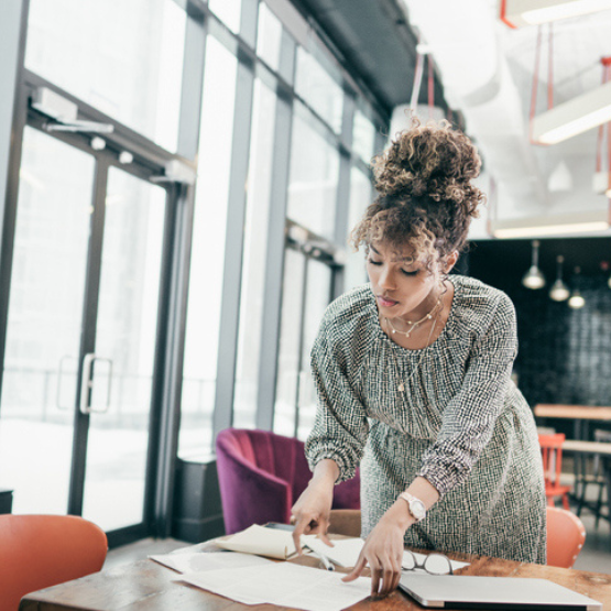 Person at desk reviewing work notes