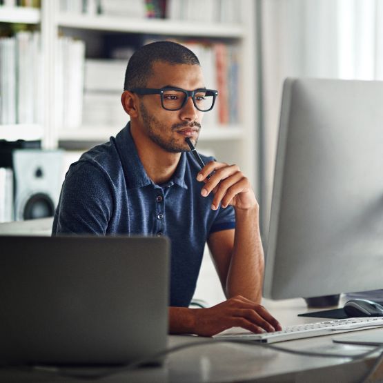 Man with glasses at computer