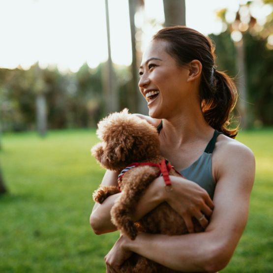 Person holding dog outside