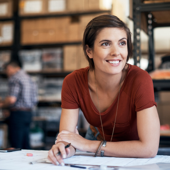 Smiling person working on paperwork at business