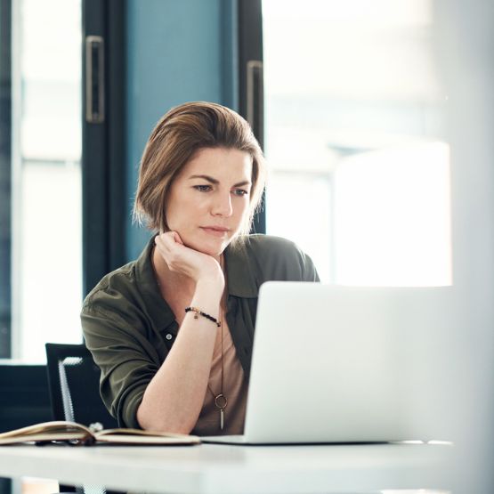 Woman in office looking at computer