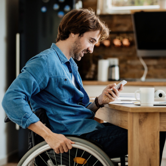 Person in wheelchair checking cell phone