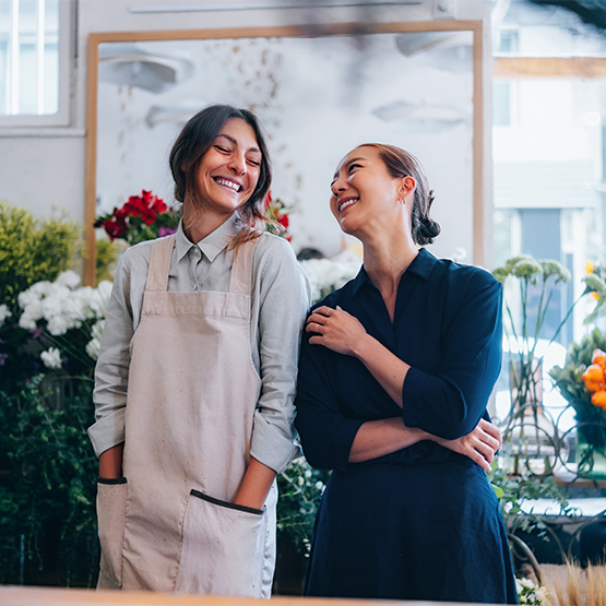 Women laughing in florist shop