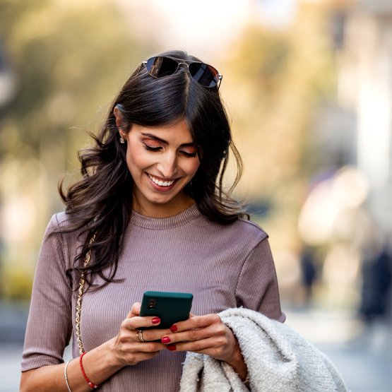 Young adult woman looking at her cell phone