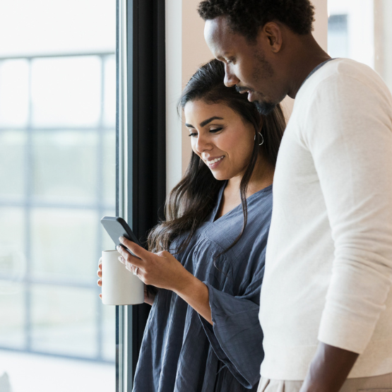 Couple looking at cell phone together