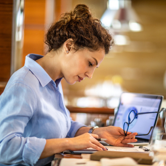 Person reviewing paperwork in office