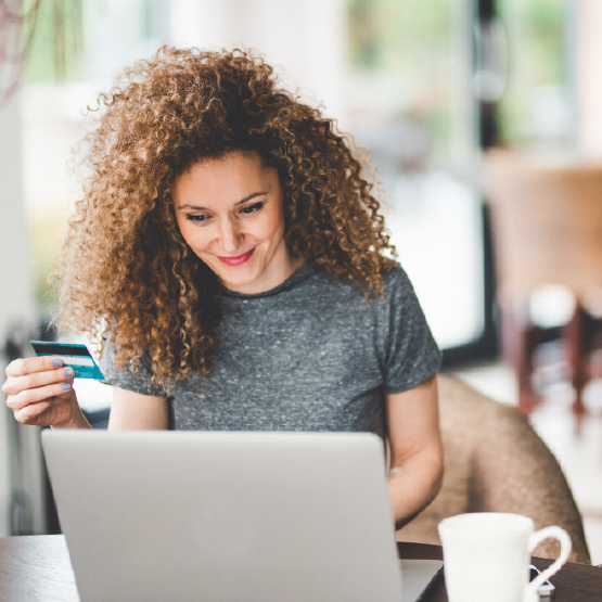 Woman with credit card using laptop