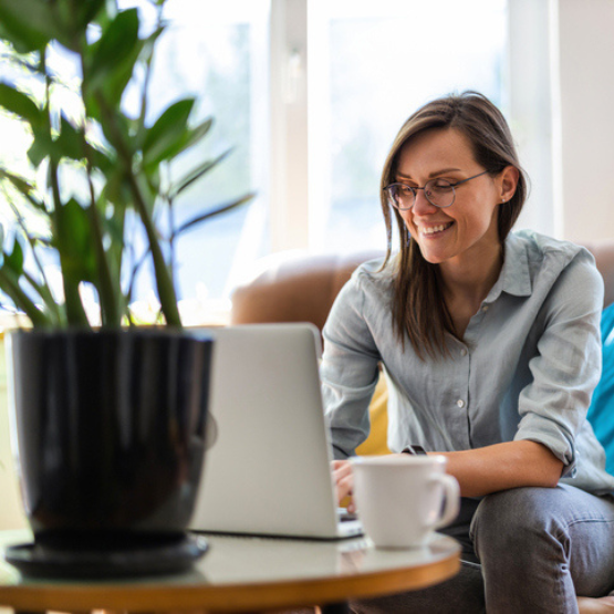 Smiling person working on laptop