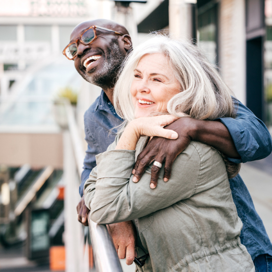 Older couple smiling and hugging