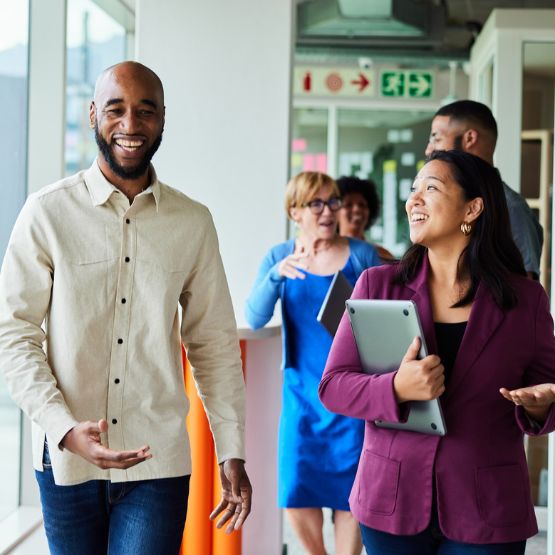 Co-workers walking down hallway