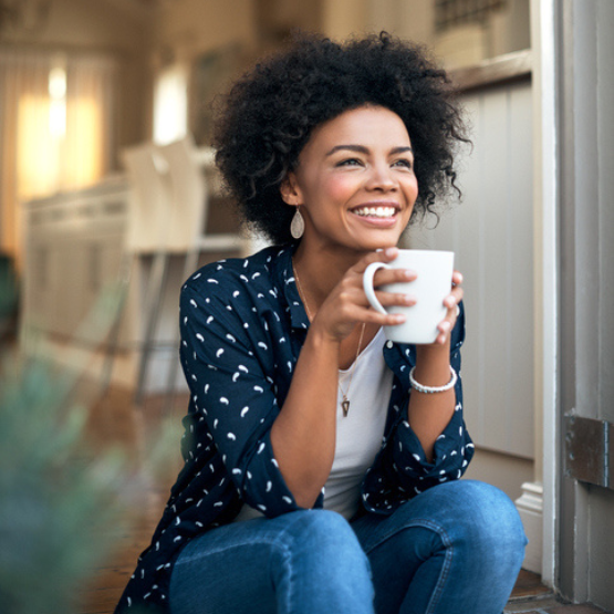 Person sitting and drinking a cup of coffee