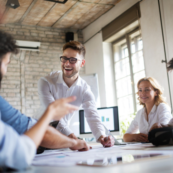 Co-workers talking in group meeting