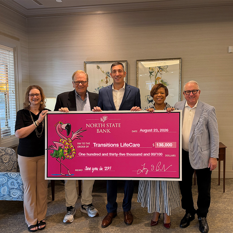 North State Bank team holding donation check for Transitions LifeCare